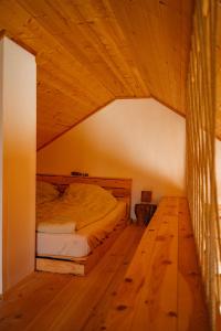 a bedroom with a bed and a wooden floor at Nonurban in Baj