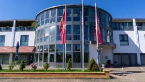 a building with three flags in front of it at Leipziger Hotel in Leipzig
