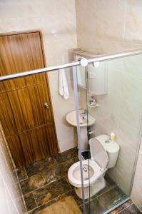 a bathroom with a toilet and a sink at Hermosa casa en Costa de Oro in Montería