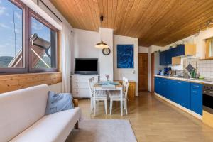 uma cozinha e sala de estar com um sofá e uma mesa em Ferienwohnung Am Samuelstein em Bad Urach