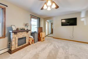 a living room with a fireplace and a television at Vermont Vacation Rental about 11 Mi to Lake Willoughby in East Charleston