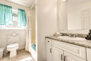 a bathroom with a sink and a toilet and a window at Vermont Vacation Rental about 11 Mi to Lake Willoughby in East Charleston +32 photos