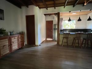 a kitchen with a counter and a table and chairs at Casa.dovale in Caeté-Açu