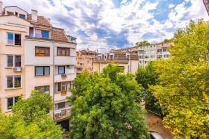 a group of buildings in a city with trees at The Plovdiv Pad: Your 1-BD Hideaway in the Center in Plovdiv