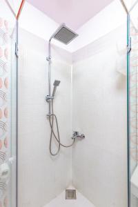 a shower with a glass door in a bathroom at The Plovdiv Pad: Your 1-BD Hideaway in the Center in Plovdiv