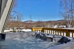 a hot tub with snow inside of a house at Rent An Inn! Takeover the Birch Ridge with your group, Mountain Lodge- 11 Rooms, Bar, Fireplace, 28ppl home in Killington