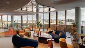 a lobby with chairs and tables and windows at W Edinburgh in Edinburgh