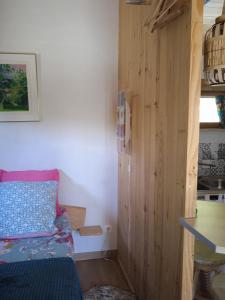a small room with a bed and a wooden wall at Chalet grenouille Domaine de la Mamounette in Champclause