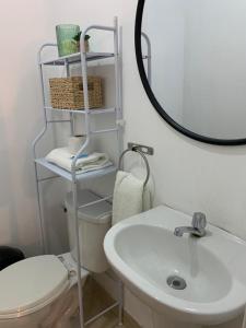 a bathroom with a sink and a toilet and a mirror at 807. Departamento entero en Chorrillos in Lima