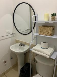 a bathroom with a sink and a mirror and a toilet at 807. Departamento entero en Chorrillos in Lima