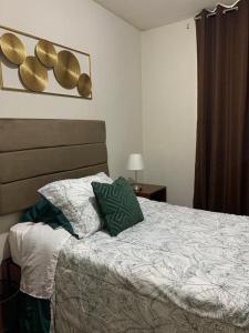 a bedroom with a bed with two pillows on it at 807. Departamento entero en Chorrillos in Lima