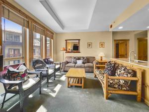a living room with a couch and chairs at Tx414 Taylors Crossing Condo in Copper Mountain