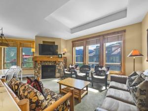 a living room with a couch and a fireplace at Tx414 Taylors Crossing Condo in Copper Mountain