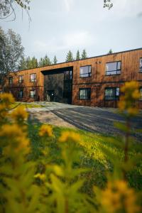 a large brick building with a large garage at Blue Hotel Fagrilundur - On The Golden Circle in Reykholt