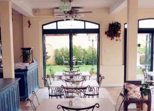 a patio with a table and chairs and a large window at Khummuangmin Boutique Hotel Nan in Nan