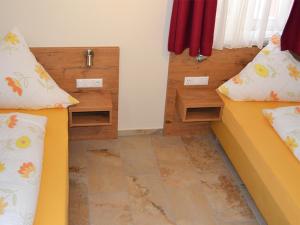 a room with two beds and two night stands at Maikäfer - a77322 in Colmberg