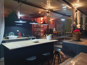 a kitchen with a counter and some stools in it at BayKus Guesthouse-Konukevi in Soke