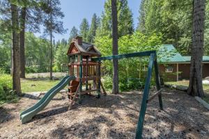 a playground with a slide and a play structure at Lil Bigfoot Chalet by NW Comfy Cabins in Leavenworth