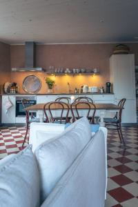 a living room with a table and chairs and a kitchen at Vaxholm Apartment in Vaxholm