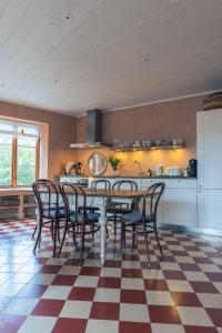 a dining room with a table and chairs on a checkered floor at Vaxholm Apartment in Vaxholm