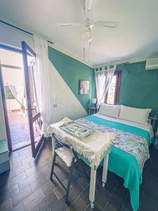 a bedroom with a bed and a table and a window at Helianthus rooms in Pula