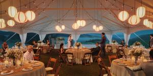 a marquee set up for a wedding with people sitting at tables at Lodge At Marconi in Marshall