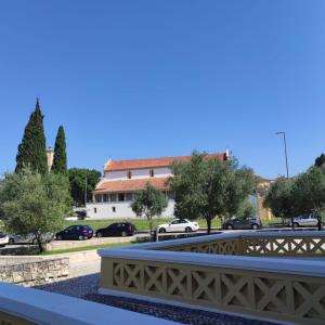 a bridge over a parking lot with cars parked at Casa Santa Maria - Tomar in Tomar