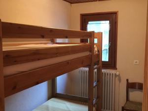 a bunk bed in a room with a window at Appartement Les Gets, 4 pièces, 6 personnes - FR-1-671-99 in Les Gets