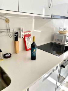 a bottle of wine sitting on a counter in a kitchen at Rio Coração in Tomar +14 photos