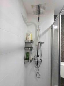 a white bathroom with a shower and a sink at Rio Coração in Tomar