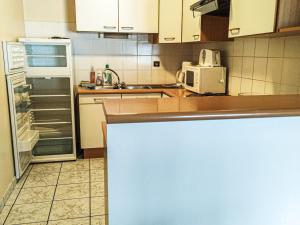 a kitchen with a refrigerator and a microwave at Appartement Les Gets, 3 pièces, 8 personnes - FR-1-671-108 in Les Gets