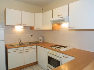 Appartement Les Gets, 3 pièces, 8 personnes - FR-1-671-108 في لي جيه: مطبخ بدولاب بيضاء ومغسلة وموقد