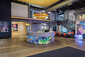 a lobby with a bar with graffiti on it at Aloft Birmingham Soho Square in Homewood