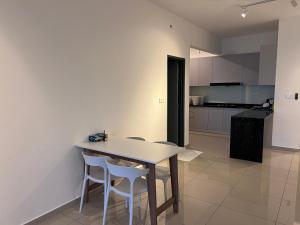 a kitchen with a table and chairs in a room at METROPOL SERVICED APARTMENT at Bukit Mertajam, Pulau Pinang in Bukit Mertajam
