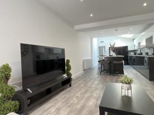 a living room with a large flat screen tv at We House - Selly Oak Birmingham in Birmingham