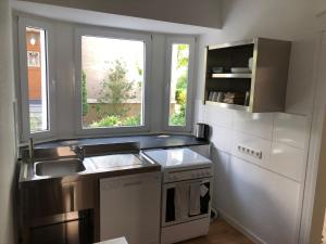 a small kitchen with a sink and a window at Work & Stay Apartments in Selm-Bork in Selm