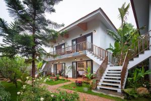 a villa with a staircase to the second floor at Bai Dinh Garden Resort & Spa in Ninh Binh