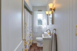 a bathroom with a sink and a toilet and a window at Cozy Greenwich Vacation Rental with Fire Pit in Greenwich +18 photos