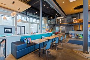 a row of tables and chairs in a restaurant at Aloft Birmingham Soho Square in Homewood