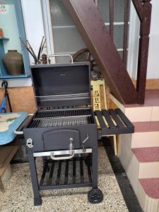 a bbq grill sitting on top of a porch at 古都101民宿 適合2至7人包棟 in Tainan