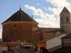 a large brick building with a tower and a church at Hostal Artiga in Alborea
