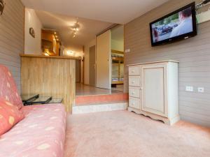 a living room with a couch and a tv on the wall at Appartement Avoriaz, 2 pièces, 5 personnes - FR-1-314-156 in Morzine