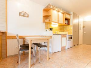 a kitchen with a wooden table and chairs at Appartement Avoriaz, 2 pièces, 5 personnes - FR-1-314-156 in Morzine