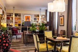 a living room with a table and chairs at La Villa Madame in Paris