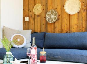 a blue couch in a living room with a table at Casa Mantana Bonaire in Kralendijk