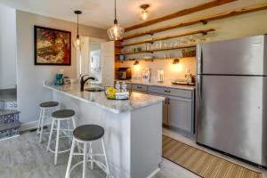 a kitchen with a stainless steel refrigerator and stools at Tranquil Cottage in Virginia Countryside with Pond! in Midlothian