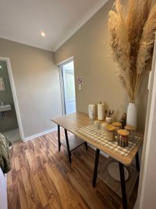 a dining room with a table with some items on it at Camellia Cottage - Courtyard Room in Cape Town