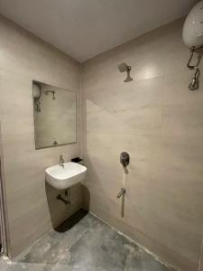 a bathroom with a sink and a mirror at Glass Luxe Villa in Mumbai