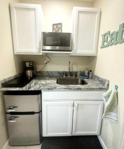 a kitchen with a sink and a microwave at Private Suite with Private Gym&Patio, Minutes to Beaches, Up to 4 Guests in Largo
