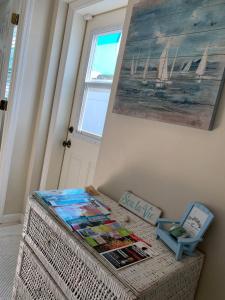 a table with magazines on it with a painting on the wall at Private Suite with Private Gym&Patio, Minutes to Beaches, Up to 4 Guests in Largo +1 photo